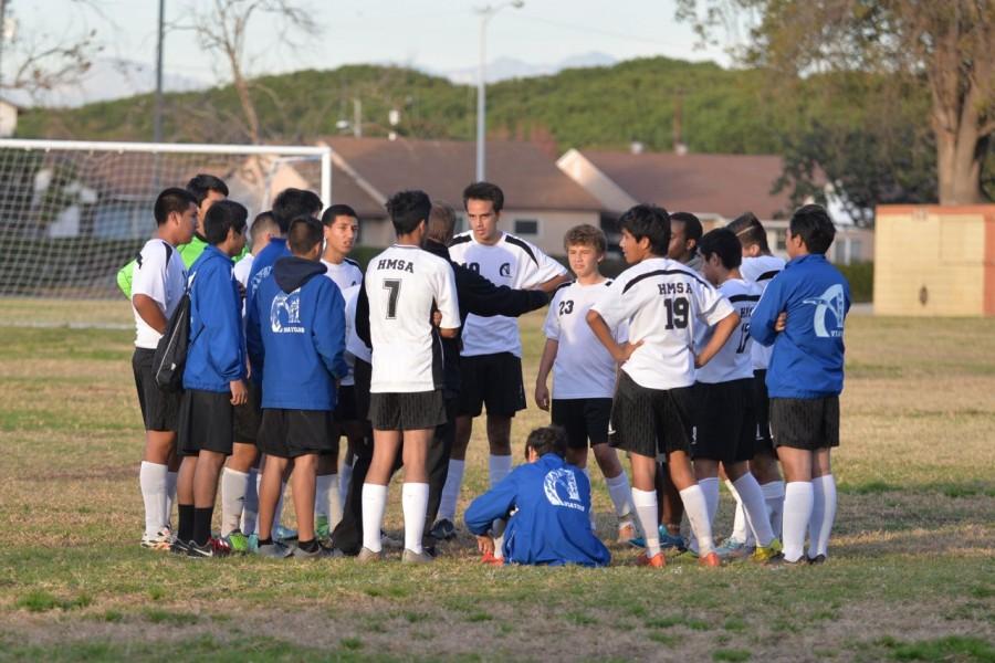 The boys soccer team huddles up after a match. Photo provided by Randy Launius.