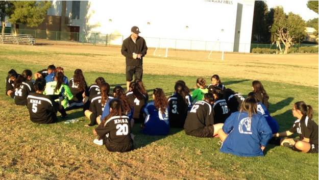 The girls huddle up during halftime to receive instructions from Coach Kircher. Photo taken by Miguel Sanchez.
