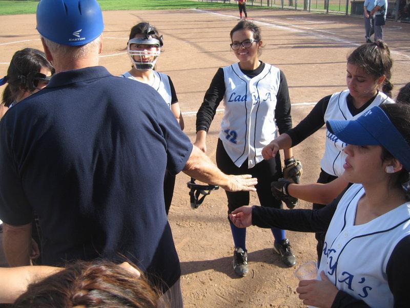 The Lady As huddle up with their coach, Mr. Dura, before a game. Photo provided by Mr. Dura.