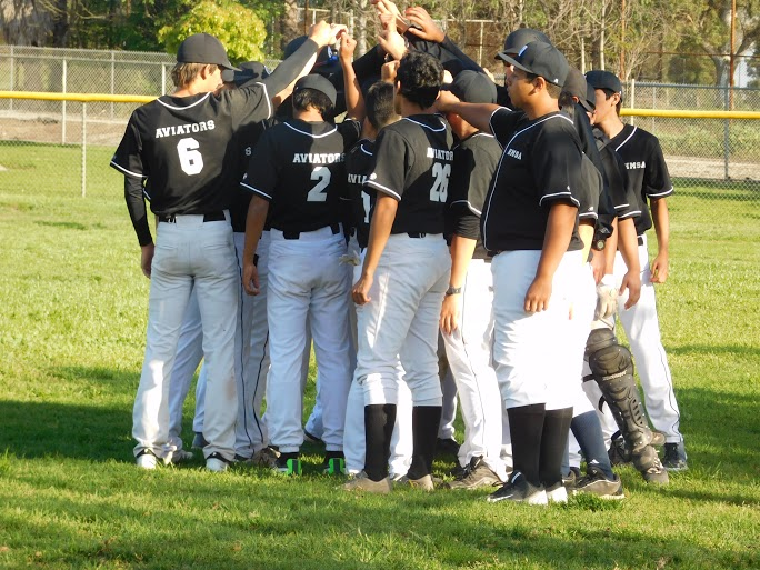 The boy’s baseball team huddle up during a game. Photo provided by Gina Sharpe.