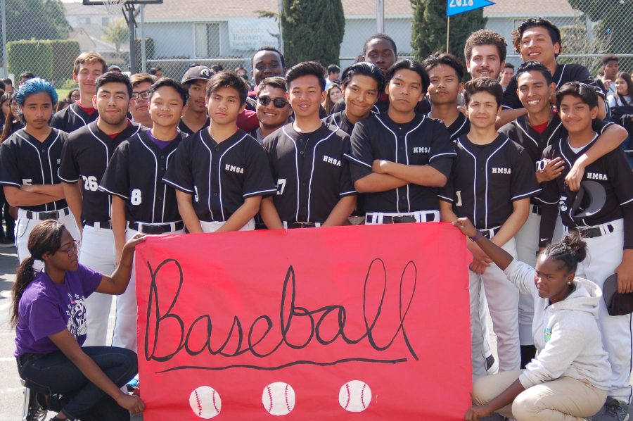 The boys baseball team come together to take a group picture. 