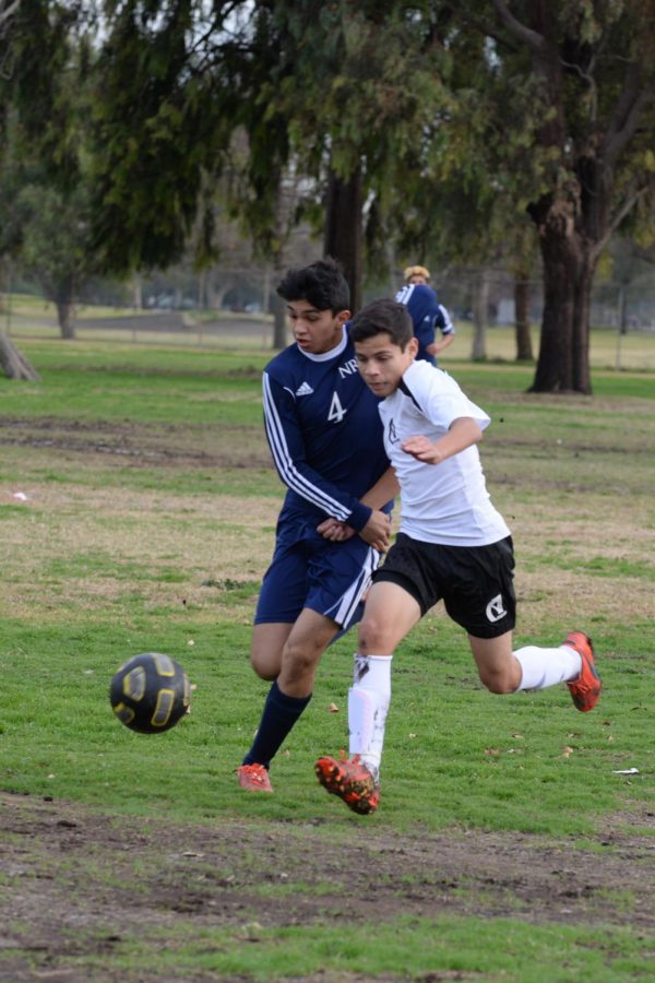 Esteban Becerra battling on a 50-50 ball against an offensive New Roads player. 
(Photo Source: Mr. Launius)