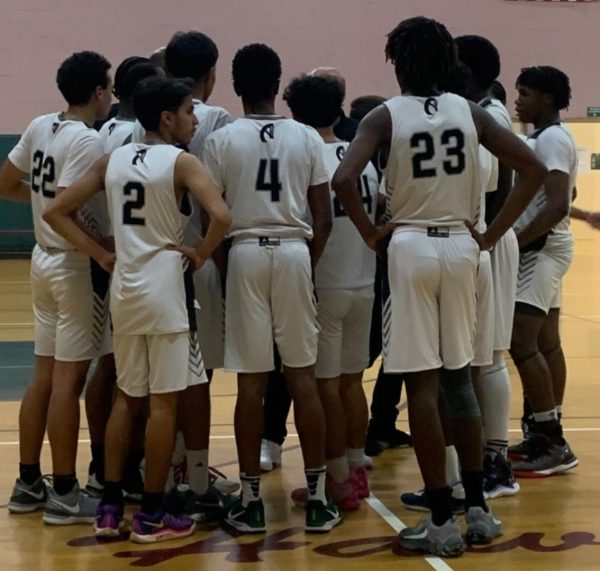 The boys Varsity are gearing up for their games as their coach offers final words of advice (Photo source: Chika Chukwuma Orakwe and Mostafa Elsharaway).