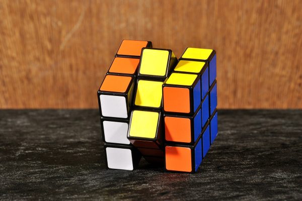 A Rubik's Cube, also known as a Magic Cube, sits against a plain background. The classic puzzle toy has challenged problem-solvers since its invention in 1974. (Kaʁstn / Wikimedia Commons)